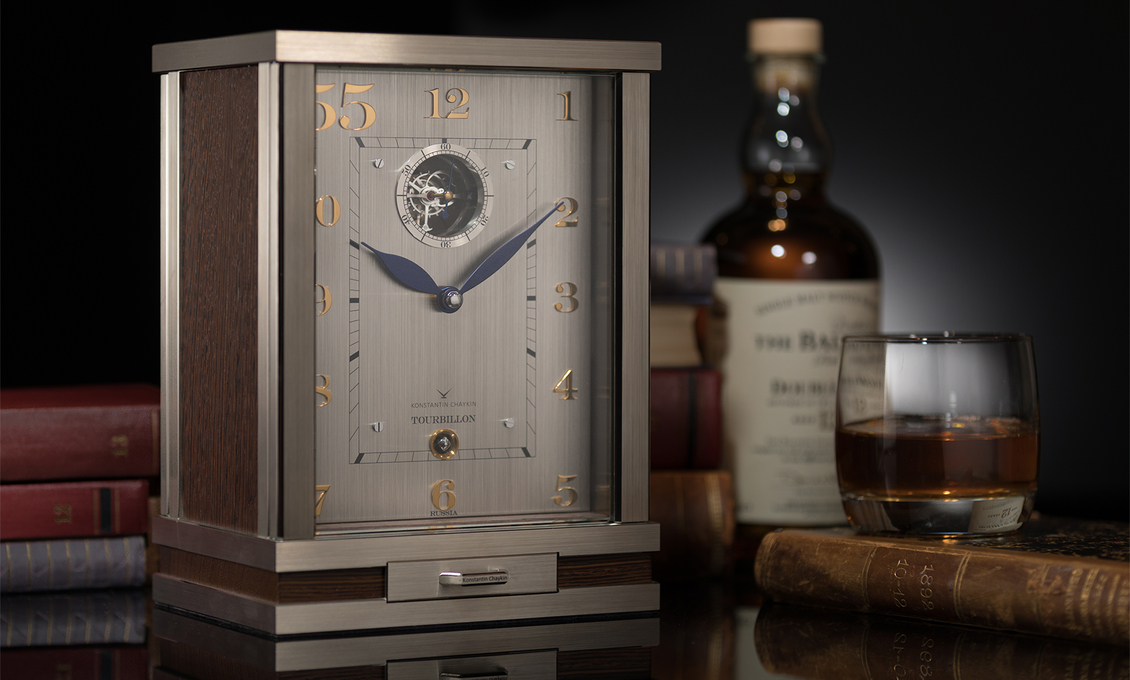 Tourbillon 55 Clock on the background of a bottle of whiskey